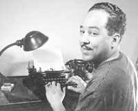 Lanston Hughes at his portable typewriter