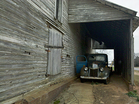 The old Ford truck tucked under a shelter near a barn on Georgia Highway 96.