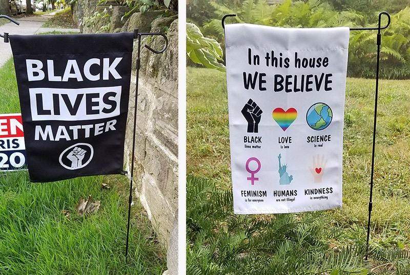 "Black Lives Matter" and "We Believe" yard banners.