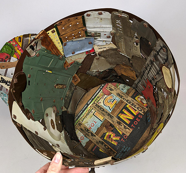 An inside view of artist Leo Sewell's trash-can with found objects. Photo from uniquesandantiques.com.